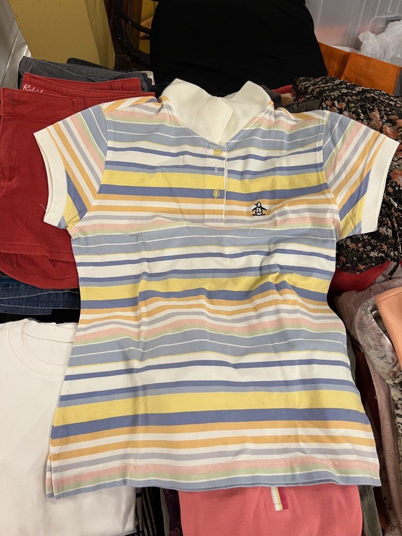 Munsingwear Striped Polo Shirt (Category: Shirts) located in Quezon City. Submitted by pasabuyshopmnl (Listing ID 1461259416, Image 1). Description: - Cute Original Penguin polo shirt - Pastel stripe pattern - Embroidered penguin logo on chest - Short sleeves - Collared neckline with button placket - Ideal for casual or sporty looks - Pairs well with shorts or jeans.