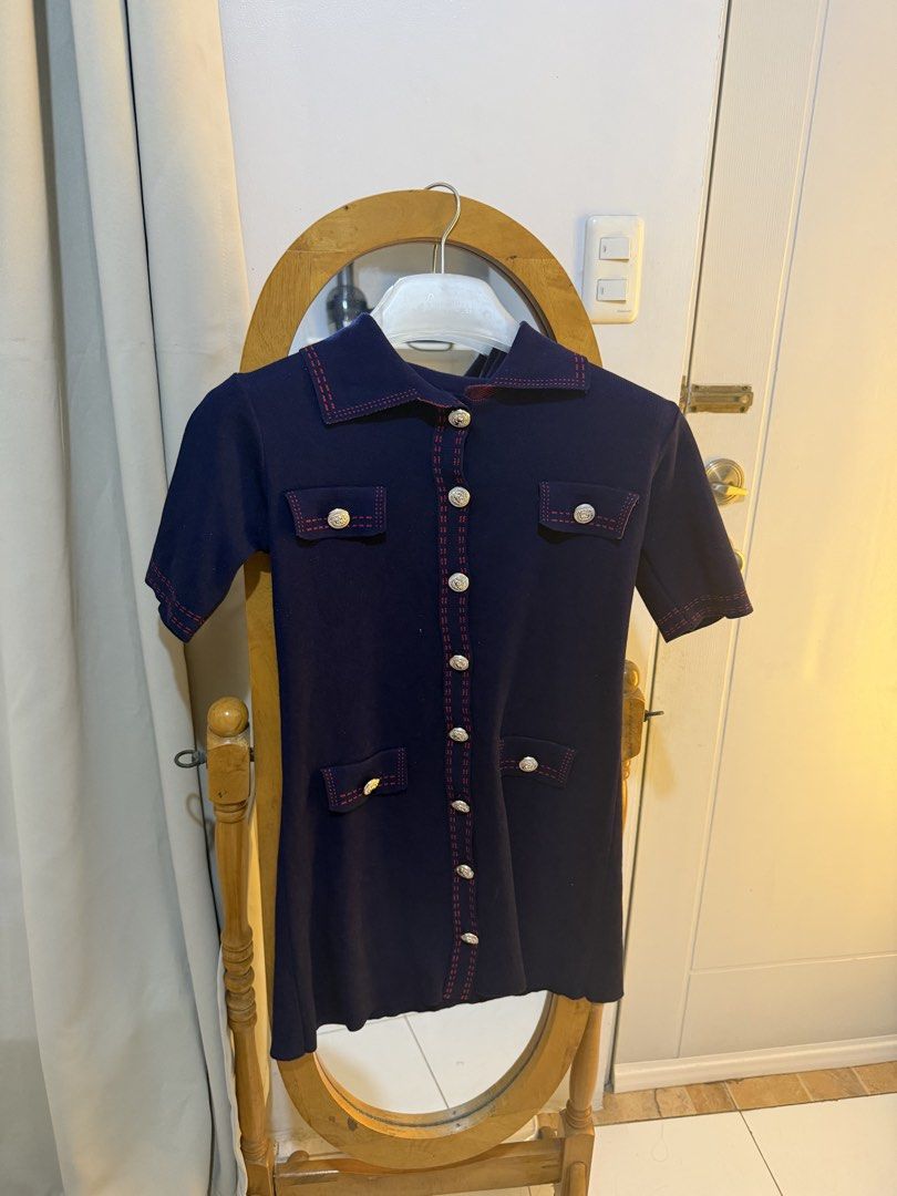 Navy Blue Collared Button-Up Dress with Red Stitching (Category: Dresses) located in Mandaluyong City. Submitted by chocofudge__ (Listing ID 1461154109, Image 1). Description: - Navy blue collared dress - Short sleeves - Button-up front - Decorative pocket details - Red contrast stitching on collar, pockets, and seams - Slight wave hem - Ideal for smart casual occasions.