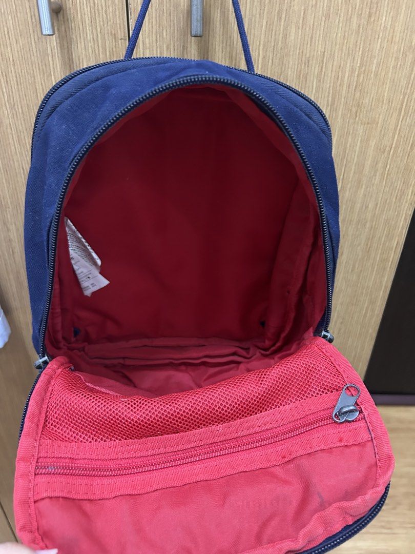 Navy Blue Nike Mini Backpack (Category: Backpacks) located in Las Pinas. Submitted by angelacat_ (Listing ID 1461258572, Image 3). Description: - Navy blue Nike mini backpack - Front zip pocket - Main compartment with red interior - can still expand the bag - Adjustable straps - Ideal for everyday use or travel Flaws: needs cleaning MoP: maribank/bdopay/gotyme.