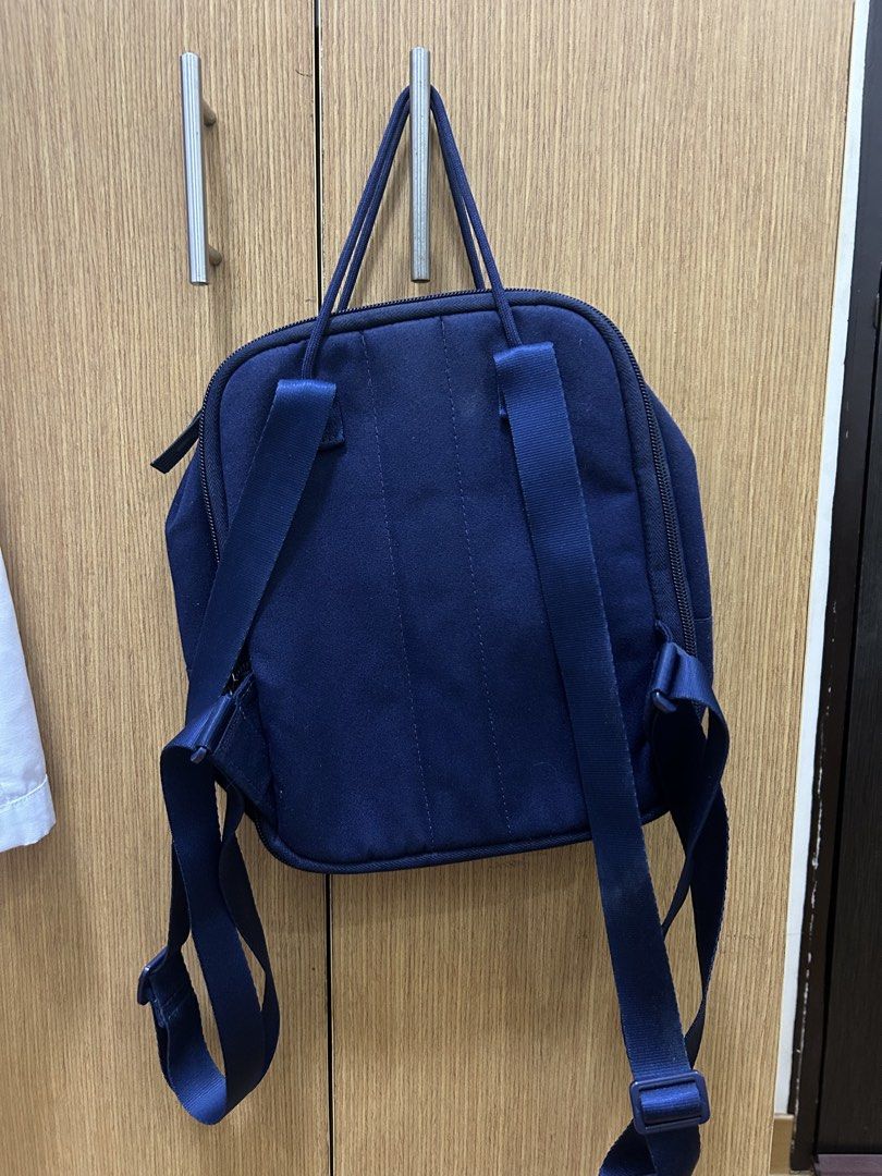Navy Blue Nike Mini Backpack (Category: Backpacks) located in Las Pinas. Submitted by angelacat_ (Listing ID 1461258572, Image 2). Description: - Navy blue Nike mini backpack - Front zip pocket - Main compartment with red interior - can still expand the bag - Adjustable straps - Ideal for everyday use or travel Flaws: needs cleaning MoP: maribank/bdopay/gotyme.