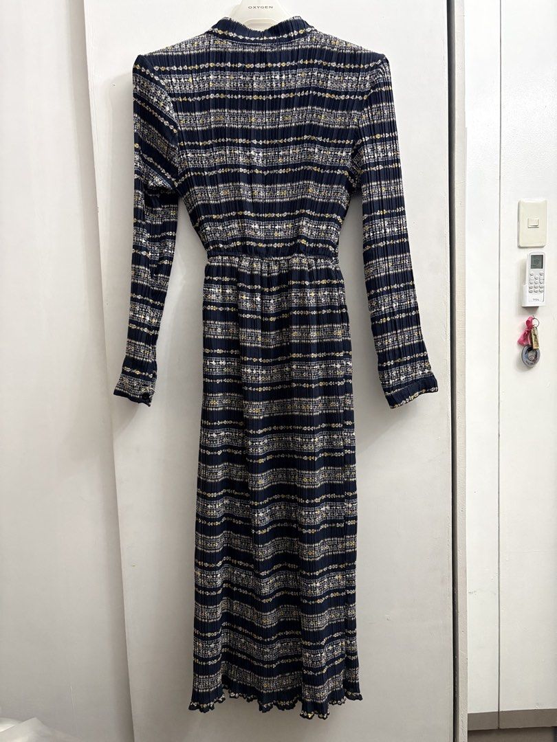 Navy Blue Pleated Midi Dress with Geometric Pattern (Category: Dresses) located in Quezon City. Submitted by thebutingthings (Listing ID 1461278598, Image 3). Description: - Elegant navy blue midi dress - Long sleeves with a sophisticated pleated texture - Eye-catching geometric pattern in white, gold, and black - Flattering cinched waist with a convenient button-up front - Feminine ruffled hem detail - Versatile for both casual outings and semi-