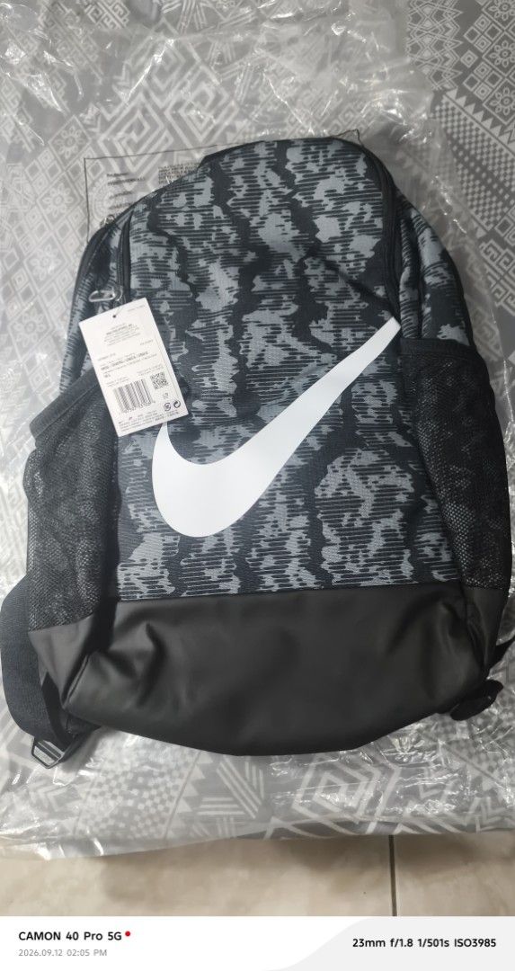 Nike Backpack 18L Camo Swoosh (Category: Backpacks) located in Mandaluyong City. Submitted by swiftbird_ed6c34 (Listing ID 1461177035, Image 1). Description: - Brand new Nike backpack - Stylish grey camo pattern with iconic white swoosh - Convenient side mesh pockets - 18L capacity, perfect for daily essentials - Still has original tags attached - Made in Vietnam.