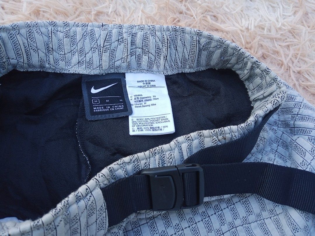 Nike Men's Grey Patterned Running Shorts Size M (Category: Shorts) located in Boston. Submitted by johnpaulvi30029 (Listing ID 1461277351, Image 3). Description: - Nike running shorts - Color: Grey with all-over pattern - Size: Medium (M) - Features: Elastic waistband with adjustable buckle belt - Origin: Made in China - Ideal for: Workouts, running, or casual wear.
