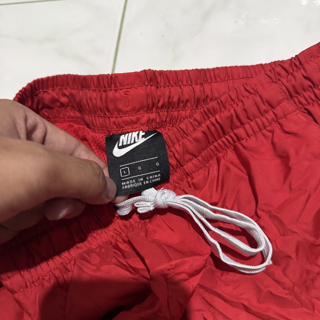 Nike Red Athletic Shorts Size L (Category: Shorts) located in Manila. Submitted by preciousma24494 (Listing ID 1461159034, Image 3). Description: - Red Nike shorts 30-33 - Elastic waistband with drawstring - Small Nike logo on left leg - Side slits for ease of movement - Back pocket with snap button closure - Ideal for sports and casual wear.