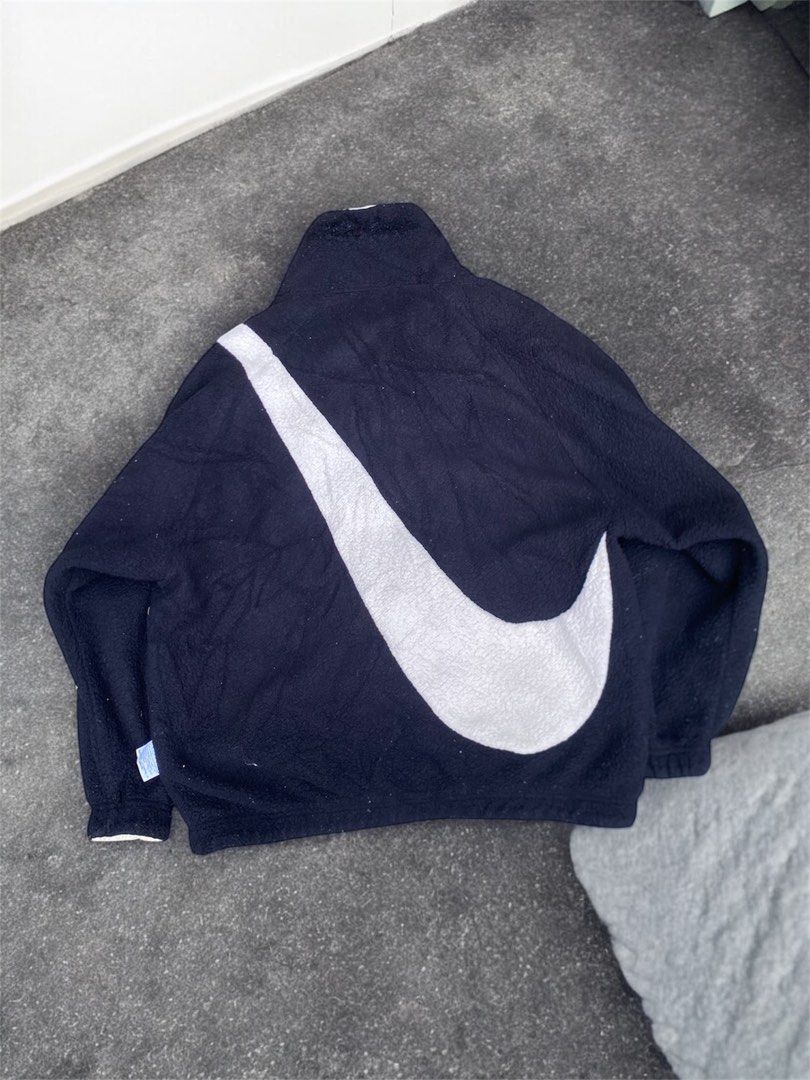 Nike Reversible Fleece & Windbreaker Jacket (Category: Coats, Jackets and Outerwear) located in General Trias. Submitted by mangu_ukay (Listing ID 1461227166, Image 2). Description: - Super cool Nike reversible jacket - Side 1: Cozy black fleece with large white swoosh - Side 2: Lightweight white windbreaker with small Nike logo - Versatile for different weather conditions - Smooth zip closure - Ideal for casual wear.