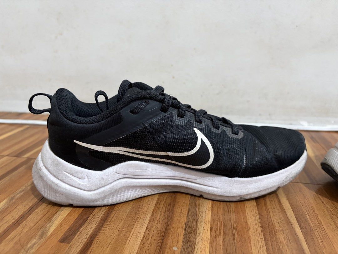 Nike Running Shoes "Just Do It" Black White (Category: Sneakers) located in Quezon City. Submitted by sctph2024 (Listing ID 1461256568, Image 2). Description: - Black Nike running shoes - White Nike swoosh logo on the side - "Nike Running Est 1972 Just Do It" text on the heel tab - White soles - Suitable for running or casual wear - Minor scuffs present on the white soles.