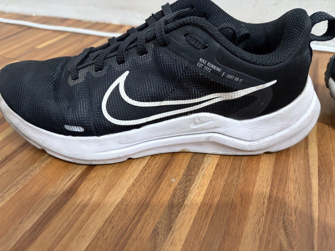 Nike Running Shoes "Just Do It" Black White (Category: Sneakers) located in Quezon City. Submitted by sctph2024 (Listing ID 1461256568, Image 3). Description: - Black Nike running shoes - White Nike swoosh logo on the side - "Nike Running Est 1972 Just Do It" text on the heel tab - White soles - Suitable for running or casual wear - Minor scuffs present on the white soles.