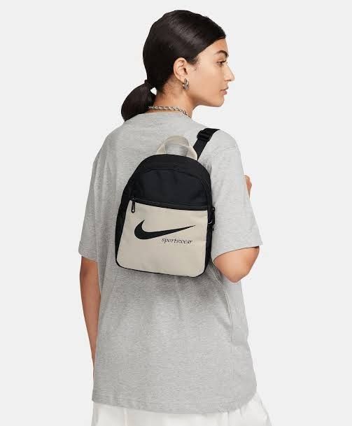 Nike Sportswear Small Backpack Black Cream (Category: Backpacks) located in Mandaluyong City. Submitted by swiftbird_ed6c34 (Listing ID 1461193638, Image 3). Description: - Classic black and cream Nike backpack - Iconic Nike swoosh and 'sportswear' branding - Convenient small front zip pocket - Adjustable straps for a comfortable fit - Ideal for everyday essentials or travel needs.