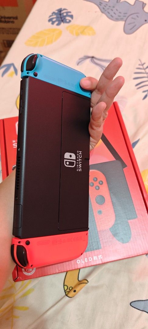 Nintendo Switch OLED Model Console with Neon Red/Blue Joy-Cons (Category: Nintendo) located in Manila. Submitted by she1026 (Listing ID 1461166824, Image 2). Description: - Nintendo Switch OLED Model - Neon Red & Blue Joy-Cons included - Original box included - Ready for home or on-the-go gaming.