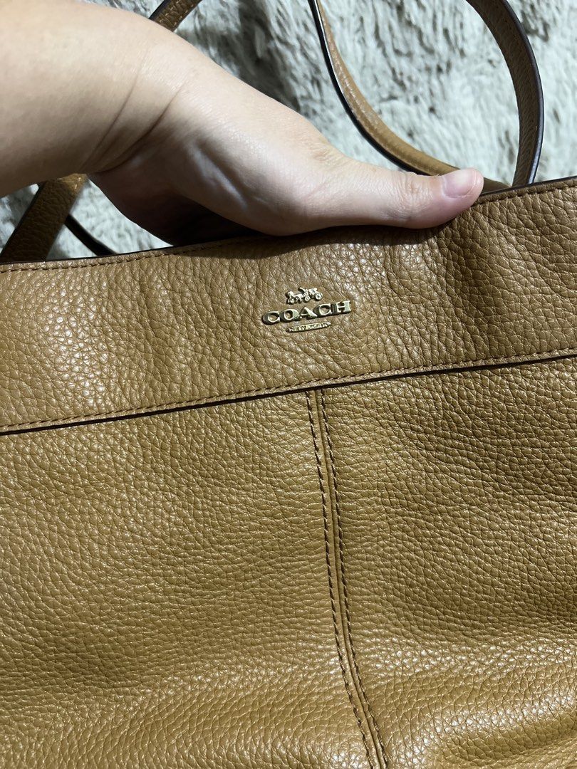 Original Coach Brown Leather Shoulder Bag (Category: Luxury Bags & Wallets) located in Manila. Submitted by princesska15212 (Listing ID 1461194698, Image 2). Description: - Authentic Coach brown leather shoulder bag - Pebble leather texture - Main zip compartment for secure storage - Two comfortable shoulder straps with elegant gold hardware - Iconic Coach leather hangtag included - Minor marks present inside the bag - Ideal for everyday use and 