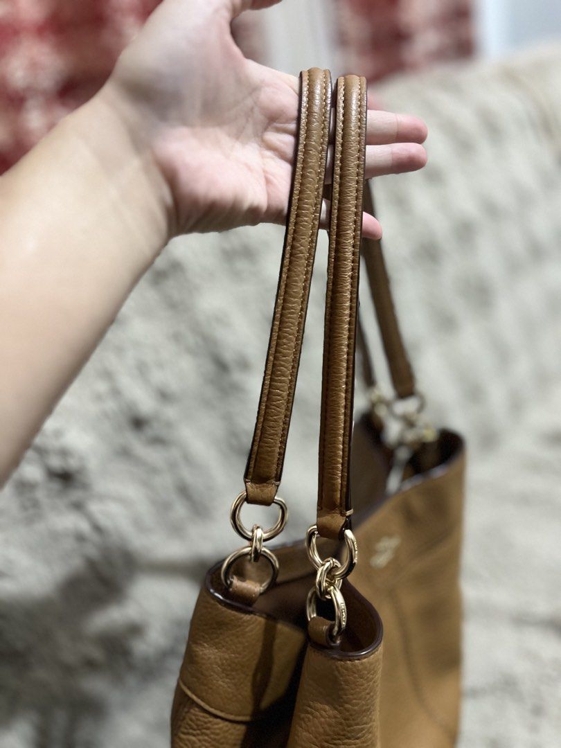 Original Coach Brown Leather Shoulder Bag (Category: Luxury Bags & Wallets) located in Manila. Submitted by princesska15212 (Listing ID 1461194698, Image 3). Description: - Authentic Coach brown leather shoulder bag - Pebble leather texture - Main zip compartment for secure storage - Two comfortable shoulder straps with elegant gold hardware - Iconic Coach leather hangtag included - Minor marks present inside the bag - Ideal for everyday use and 