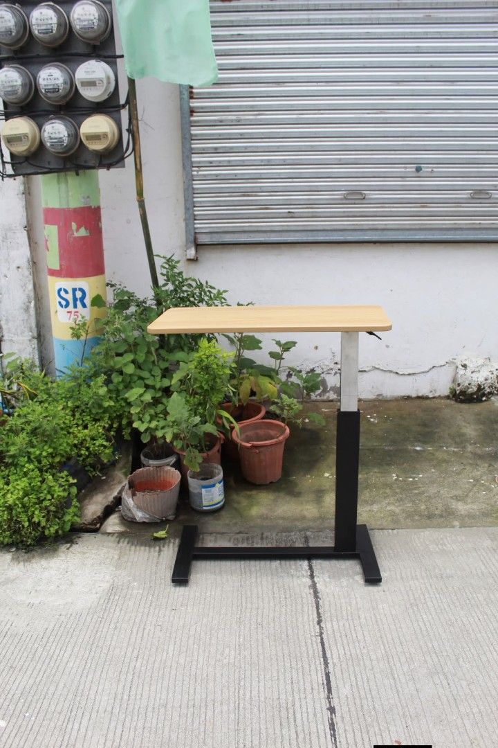 Overbed Table (Category: Tables & Sets) located in Meycauayan. Submitted by marygracecasimiro (Listing ID 1461225470, Image 1). Description: Adjustable Mobile Overbed Table Adjustable mobile overbed table with a height-adjustable column, spacious wood-grain tabletop and smooth-rolling caster base. Perfect for use as a bedside table, laptop desk, reading table or work surface L:31 ½ • W:15 ¾ • H:26 up to 37 ½ inches 3,500 pesos only🧡.