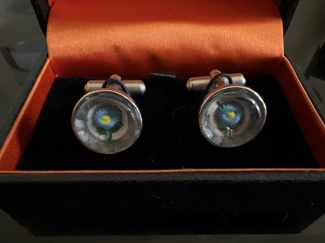 Paul Smith Cufflinks - Two Pairs (Category: Cuff Links) located in Manila. Submitted by mikimae777 (Listing ID 1461168413, Image 3). Description: - Authentic Paul Smith cufflinks - Two distinct styles available: - Engraved 'Paul Smith' on oval stones - Blue flower design under glass - Both pairs come with original Paul Smith boxes - Ideal accessories to complete your formal wear.