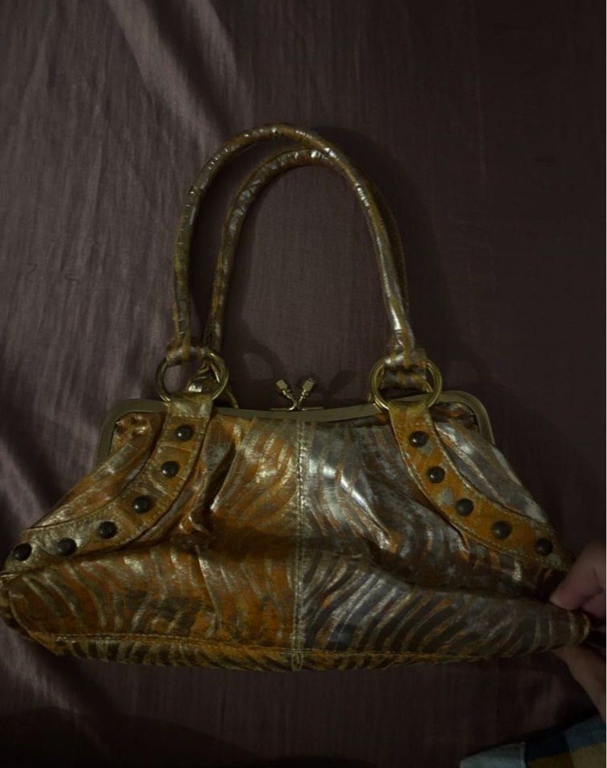 Pegaso Milano Gold Y2K bag (Category: Shoulder Bags) located in Quezon City. Submitted by skinnyshopaholic (Listing ID 1461231538, Image 2). Description: Measures approximately 12 inches wide and 7 inches tall. Can fit iPhone pro max. Decluttering!.