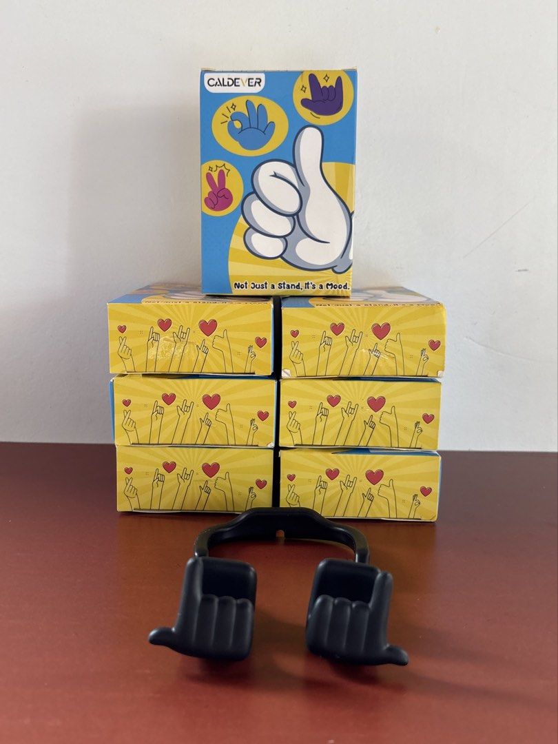 Phone & Tablet Stand “Mood Moves Series — CALDEVER” (sealed) (Category: Mounts & Holders) located in Cavite. Submitted by nanangonlineshop (Listing ID 1461117685, Image 1). Description: 📌 Phone & Tablet Stand “Mood Moves Series — CALDEVER” (sealed) 🏷️ P25 (1 pc. per pack) 🏷️ P50 (2 pcs. per pack) ✅ Design Concept: Flexible hand-gesture shapes (such as the “Thumbs Up”, “Peace Sign/Yeah Vibe”, and “Rock On” gestures) that wrap around your device