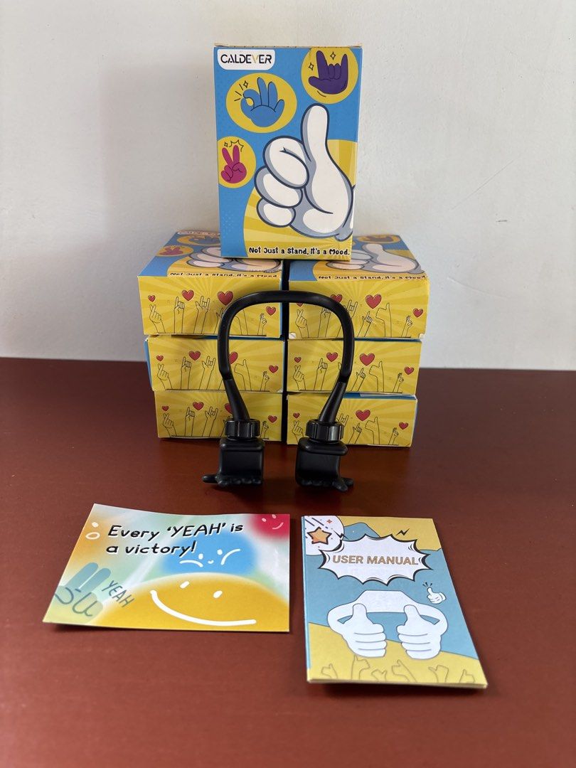 Phone & Tablet Stand “Mood Moves Series — CALDEVER” (sealed) (Category: Mounts & Holders) located in Cavite. Submitted by nanangonlineshop (Listing ID 1461117685, Image 2). Description: 📌 Phone & Tablet Stand “Mood Moves Series — CALDEVER” (sealed) 🏷️ P25 (1 pc. per pack) 🏷️ P50 (2 pcs. per pack) ✅ Design Concept: Flexible hand-gesture shapes (such as the “Thumbs Up”, “Peace Sign/Yeah Vibe”, and “Rock On” gestures) that wrap around your device