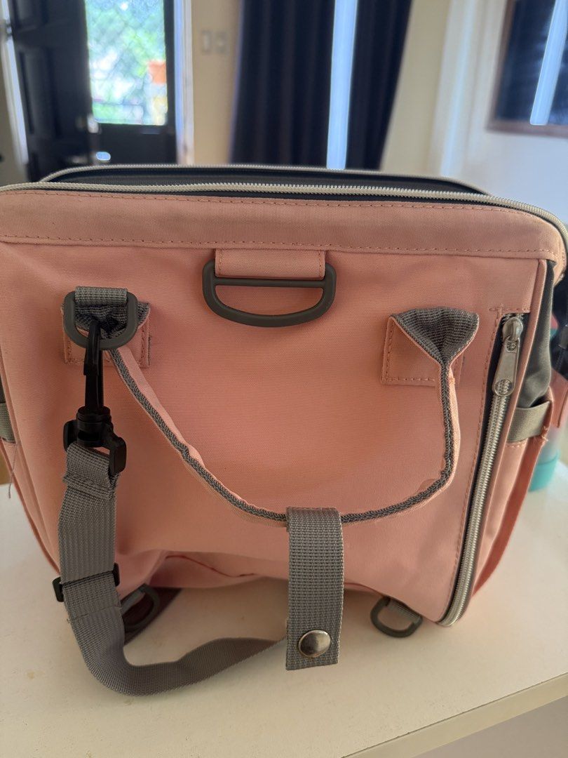 Pink and Grey Diaper Bag with Multiple Compartments (Category: Diaper Bags & Wetbags) located in Dagupan City. Submitted by namishin18 (Listing ID 1461174175, Image 2). Description: - Chic pink and grey diaper bag - Large main zippered compartment - Multiple internal pockets for organization - Convenient front zippered pocket - Adjustable straps for comfortable carrying - Includes a detachable shoulder strap - Ideal for organizing and carrying ba