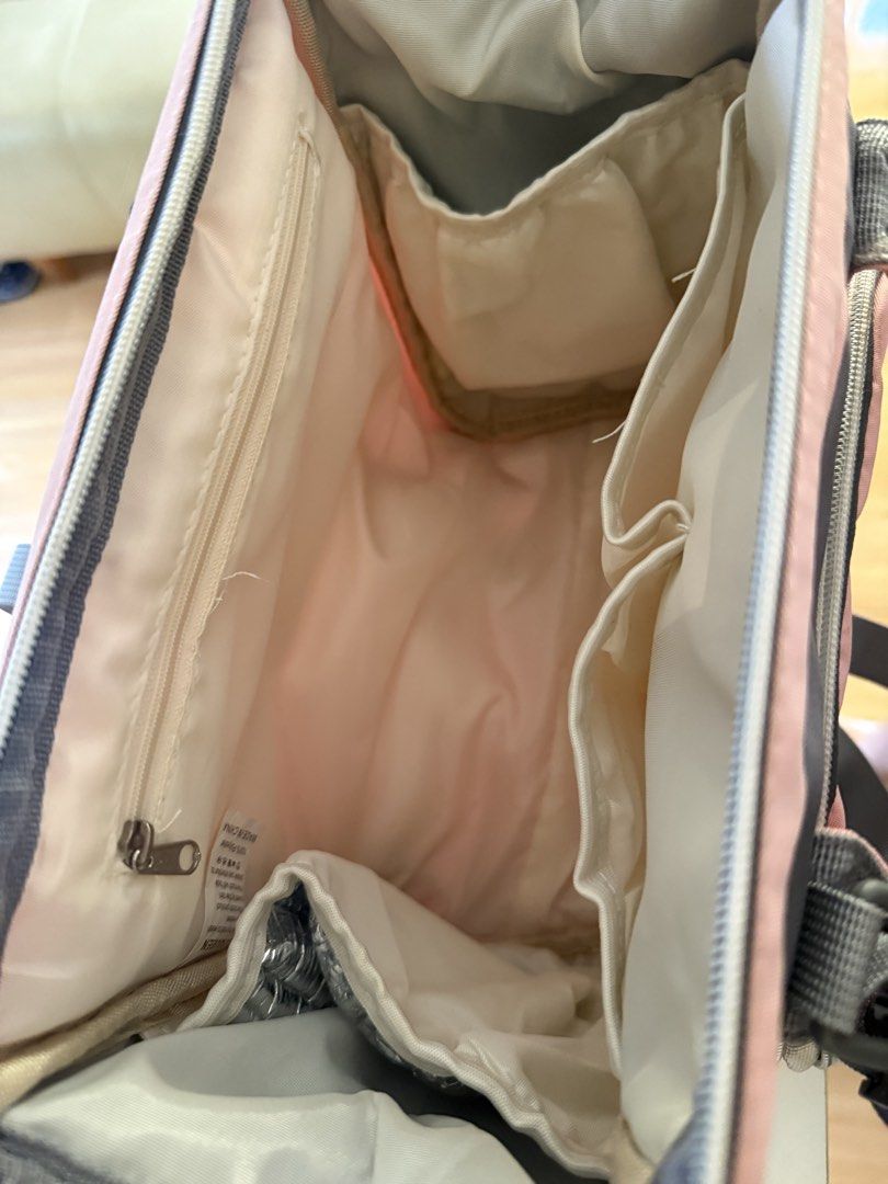 Pink and Grey Diaper Bag with Multiple Compartments (Category: Diaper Bags & Wetbags) located in Dagupan City. Submitted by namishin18 (Listing ID 1461174175, Image 3). Description: - Chic pink and grey diaper bag - Large main zippered compartment - Multiple internal pockets for organization - Convenient front zippered pocket - Adjustable straps for comfortable carrying - Includes a detachable shoulder strap - Ideal for organizing and carrying ba