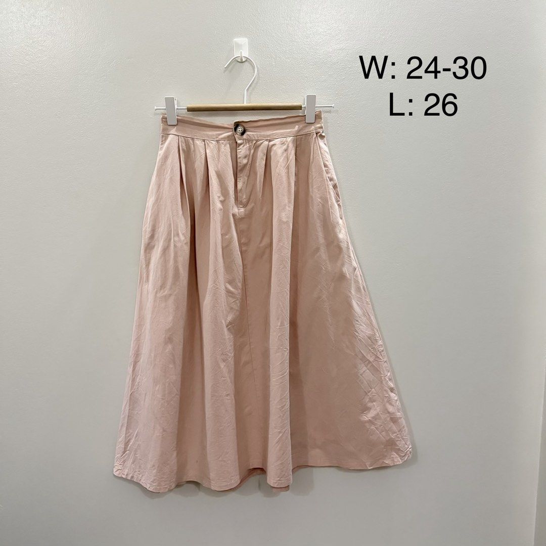 Pink Pleated Midi Skirt (Category: Skirts) located in Rodriguez. Submitted by jrms23 (Listing ID 1461157899, Image 1). Description: - Light pink midi skirt - Pleated waist detail - Button closure - Functional pockets - Waist fits 24-30 inches - Length is 26 inches - Versatile for casual and dressy outfits.