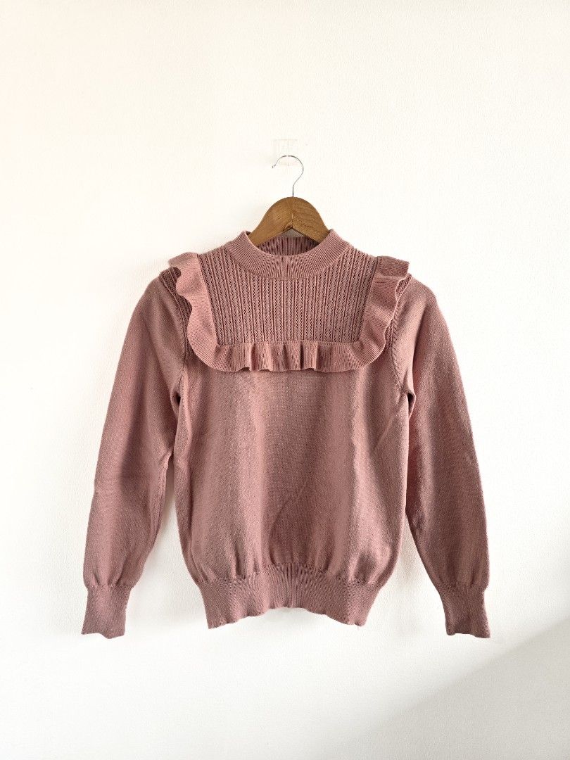 Pink Ruffle Knit Sweater (Category: Coats, Jackets and Outerwear) located in San Juan City. Submitted by janda.slctns (Listing ID 1461272719, Image 1). Description: Color: Light Pink Pattern: Solid Knit Size: Not tagged (see dimensions for fit reference; Fits S-M frame) Features: Stretchable; Ruffled collar and shoulder details, ribbed cuffs and hem, soft knit texture Condition: Good condition Dimensions: • Shoulder width: ~45 cm • Full length: ~