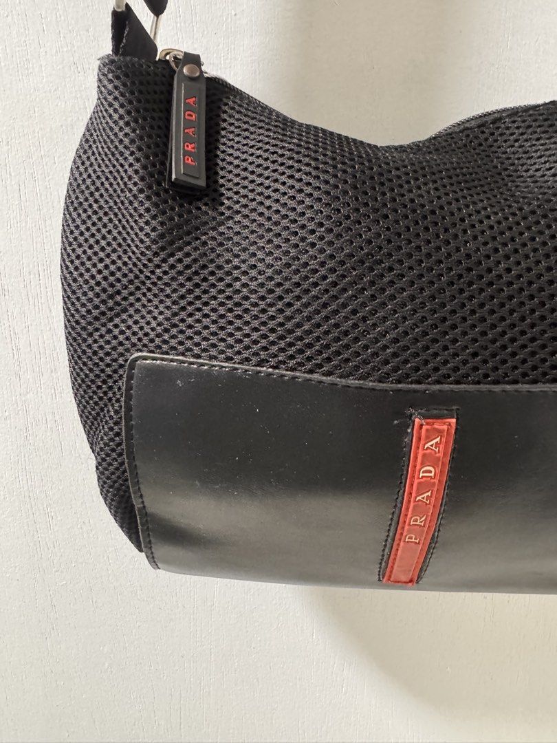 Prada Black Mesh Shoulder Bag with Leather Trim (Category: Luxury Bags & Wallets) located in Cavite. Submitted by aldrindela40142 (Listing ID 1461320696, Image 3). Description: - Authentic Prada shoulder bag - Color: Black - Material: Mesh with leather accents - Features Prada logo on leather tag and hardware - Closure: Zipper - Strap: Adjustable - Ideal for everyday use.