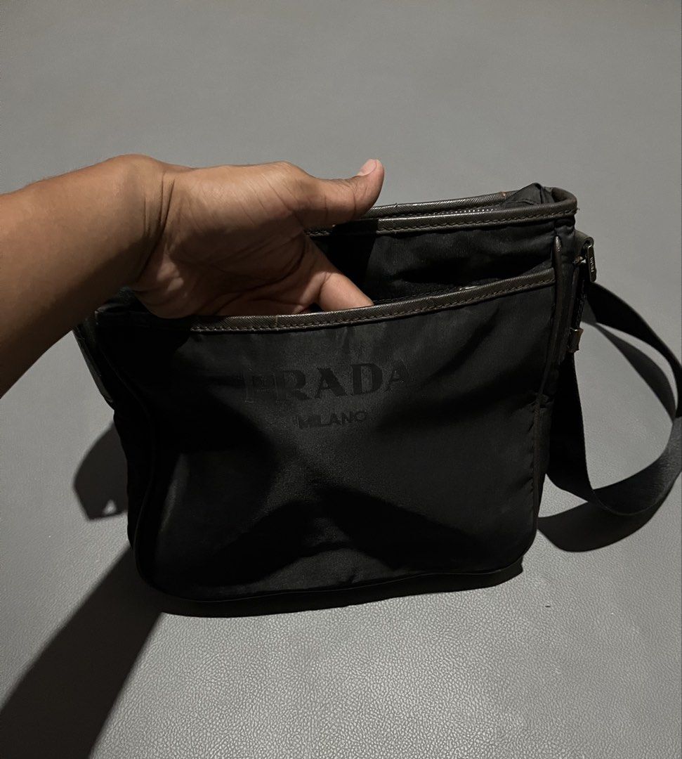 Prada Nylon Crossbody Bag Black (Category: Luxury Bags & Wallets) located in General Santos City (Dadiangas). Submitted by thiftnibadi3 (Listing ID 1461235262, Image 3). Description: - Authentic Prada crossbody bag - Black nylon material - Iconic Prada logo on front - Interior zip pocket - Adjustable strap for comfort - Ideal for everyday use - Made in Italy.