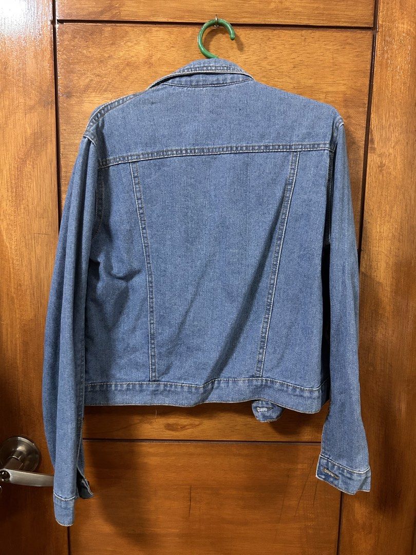 PRELOVED Blue Denim Jacket (Category: Coats, Jackets and Outerwear) located in Muntinlupa City. Submitted by an.declutters (Listing ID 1461229593, Image 2). Description: PRELOVED Blue Denim Jacket Selling for ₱200 ✔️ Classic blue denim jacket ✔️ Distressed details on front and sleeves ✔️ Button-up closure ✔️ Two chest pockets ✔️ Ideal for layering ✔️ Versatile styling – pairs well with anything ✔️ Size large on tag, please see actual measurement 