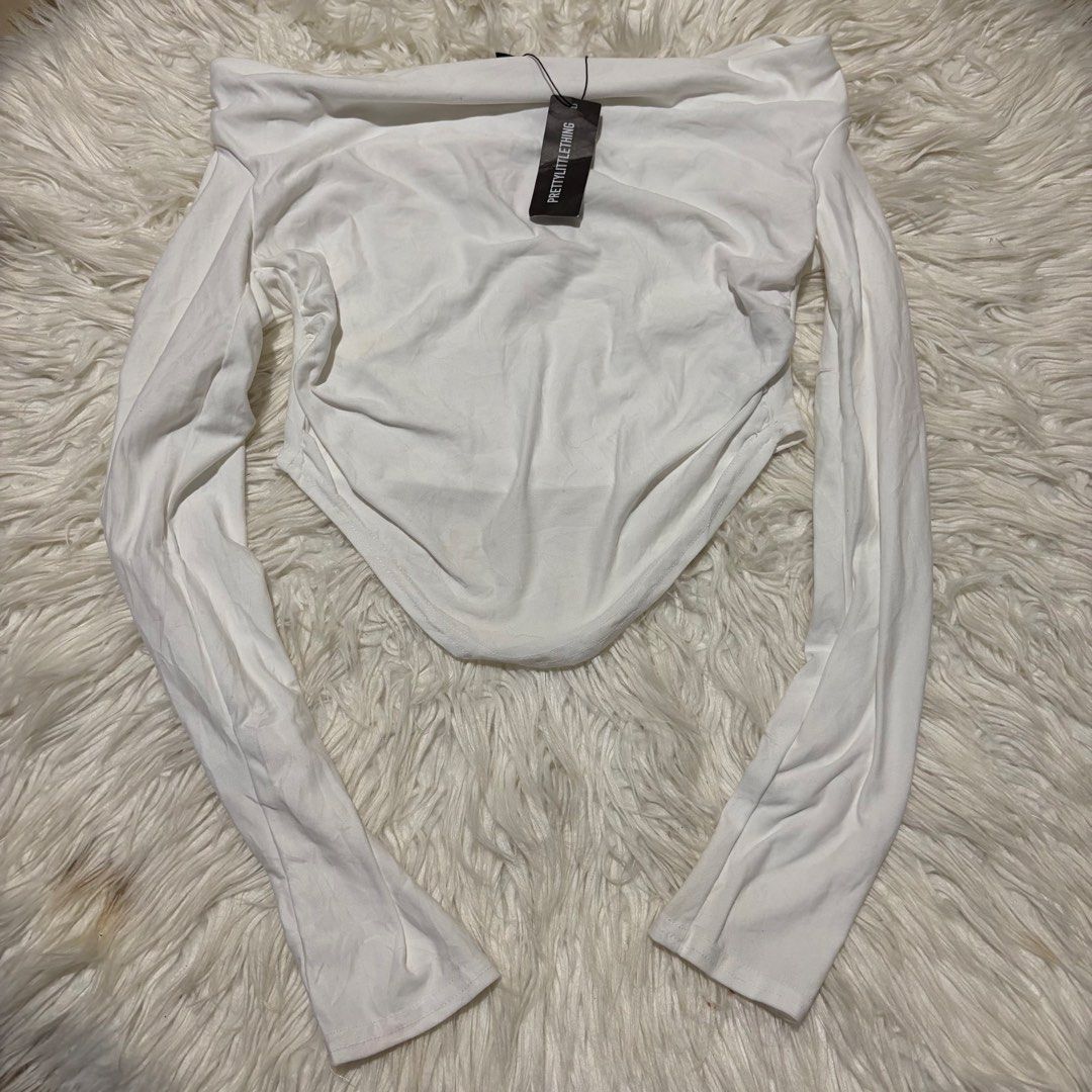 PrettyLittleThing White Long Sleeve Corset Top (Category: Others Tops) located in Davao. Submitted by elizzadiac (Listing ID 1461239228, Image 1). Description: - Brand new white long sleeve top from PrettyLittleThing - Off-shoulder design with a corset-style hem - Estimated size: UK 8 / EUR 36 / US 4 - Made in Morocco - Tags still attached.