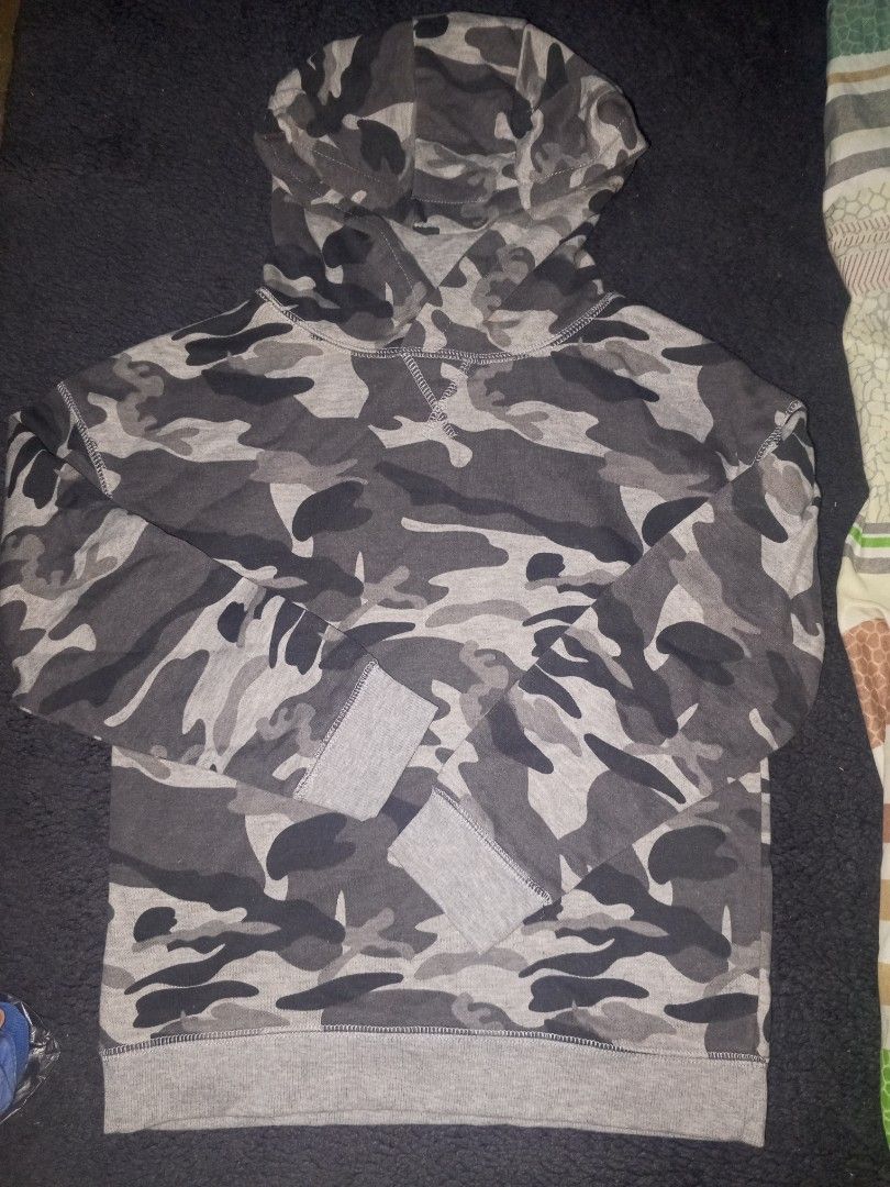 Primark Camouflage Hoodie (Category: Babies & Kids Fashion) located in Magalang. Submitted by zeiansoria64090 (Listing ID 1461236525, Image 1). Description: - Grey and black camouflage hoodie from Primark - Long sleeves with ribbed cuffs - Ribbed hem - Hood with drawstring - Made in Cambodia - Ideal for casual wear.