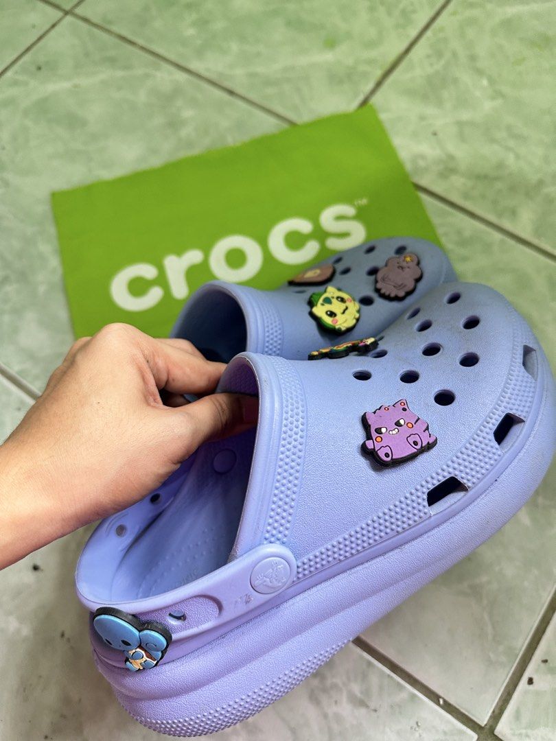 Purple Crocs with Charms (Category: Slippers and slides) located in Tuguegarao City. Submitted by oddphoenix_e9d6d4 (Listing ID 1461129483, Image 2). Description: - 100% OG (Kuwait Bought) - Light purple Crocs - Adorable charms included - Easy slip-on and off design - Ideal for casual everyday wear - Comes with a complimentary green Crocs bag.