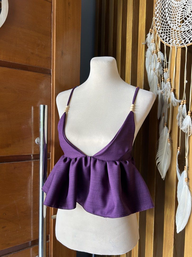 Purple Peplum Crop Top with Beaded Straps (Category: Sleeveless) located in Banaybanay. Submitted by rethread.co (Listing ID 1461117761, Image 1). Description: - Adorable purple peplum crop top - Features adjustable spaghetti straps with charming wooden beads - Fun, flowy peplum hem for a playful silhouette - Ideal for summer days or stylish nights out - Versatile piece: easily pairs with jeans or skirts.