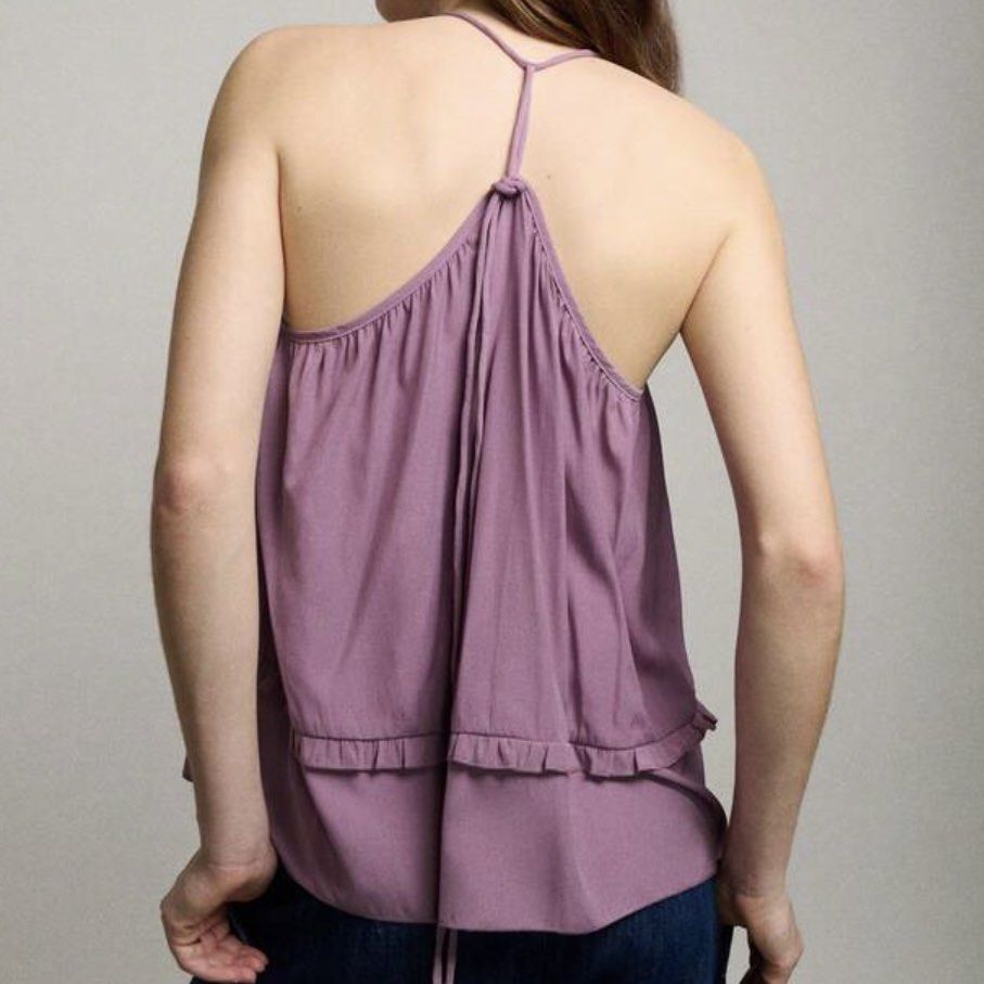 Purple Ruffled Halter Neck Tank Top (Category: Sleeveless) located in Makati City. Submitted by midnightmelhem (Listing ID 1461140137, Image 2). Description: - Cute purple tank top - Halter neck with tie-back detail - Ruffled hemline - Lightweight and flowy material - Perfect for casual wear or layering.