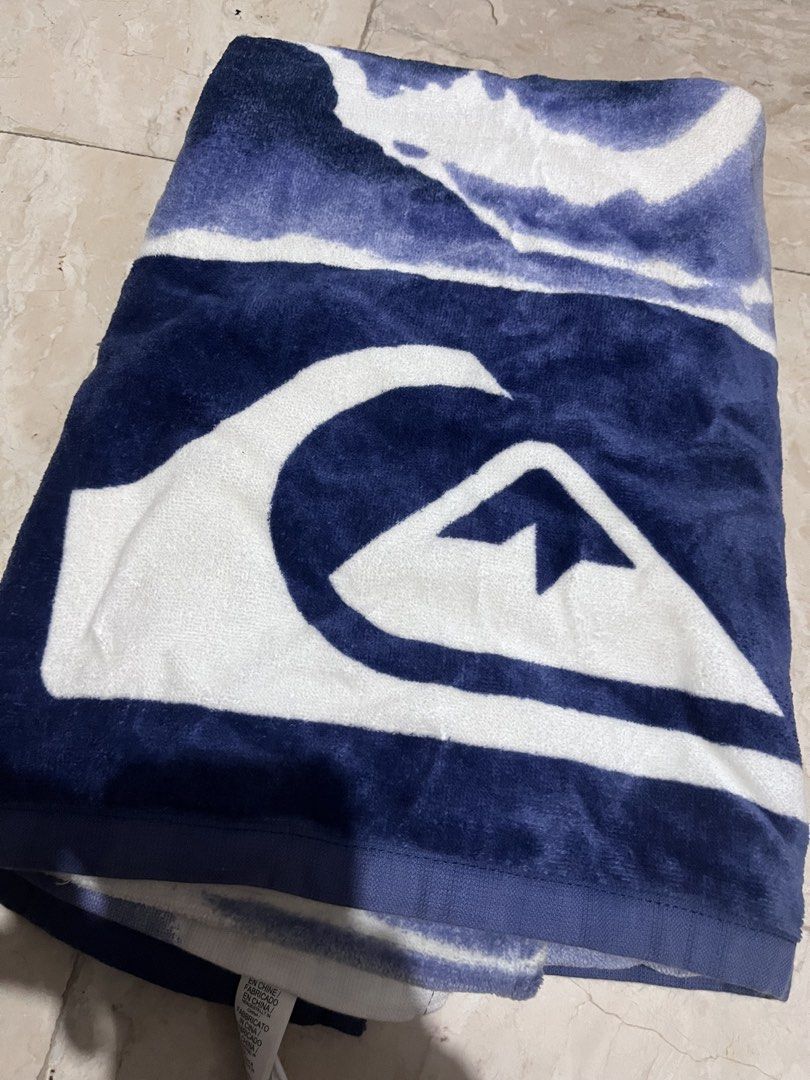 Quiksilver Large Beach Towel (Category: Water Sports) located in Las Pinas. Submitted by albert_lp (Listing ID 1461243986, Image 1). Description: - Authentic Quiksilver beach towel - Features iconic blue and white wave logo - Made from soft and absorbent material - 60 in x 33 in - defect: minor stains from use and very slight discoloration of the backside (shown in pic).