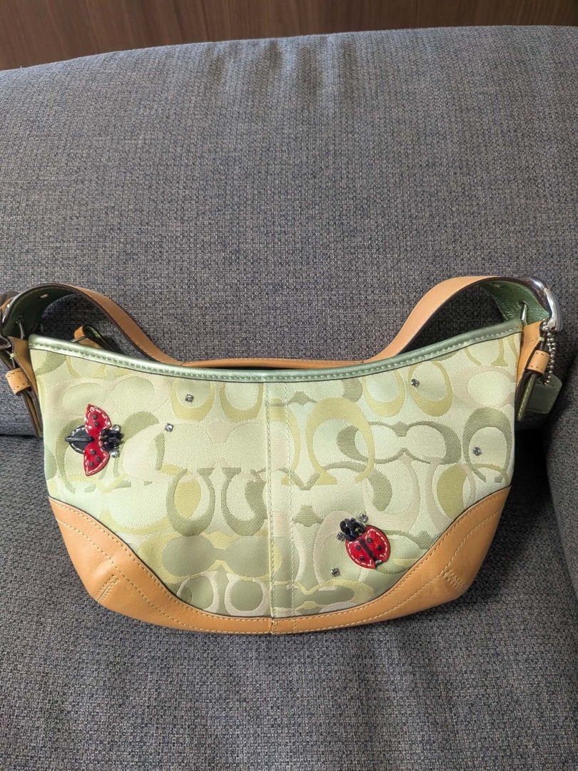 RARE Coach Lady Bug Optic Soho Shoulder Bag (Category: Luxury Bags & Wallets) located in Makati City. Submitted by aurevelle.vintage (Listing ID 1461244389, Image 1). Description: [𝙍𝘼𝙍𝙀] ⋆.𐙚 ̊ Coach Soho Lady Bug in Green & Brown ⟡ very rare to find! ⟡ 𝙀𝙏𝘼: last week of September ⟡ 𝙎𝙞𝙯𝙚: small ⟡ 𝘿𝙞𝙢𝙚𝙣𝙨𝙞𝙤𝙣𝙨: ⟡ 𝙋𝙧𝙤𝙙𝙪𝙘𝙩 𝘾𝙤𝙣𝙙𝙞𝙩𝙞𝙤𝙣 𝙍𝙖𝙣𝙠: S ⟡ 𝙄𝙨𝙨𝙪𝙚/𝙨: excellent condition ⟡ 𝙊𝙥𝙚𝙣 𝙁𝙤𝙧 𝙇𝙖𝙮𝙖𝙬𝙖𝙮: 