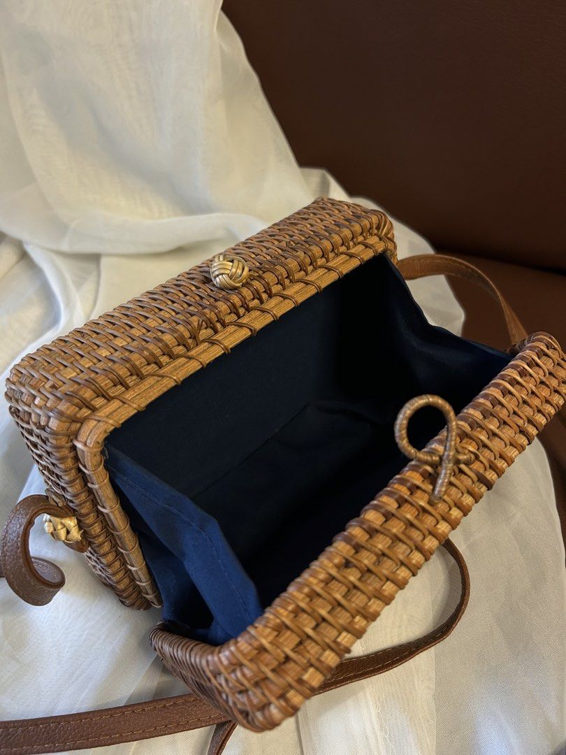RATTAN SLING BAG (Category: Cross-body Bags) located in Baguio. Submitted by chmlnstudio (Listing ID 1461297269, Image 3). Description: Product Details ✦ Style & Form: Structured rectangular box bag / crossbody shoulder bag Material: ⟡ Hand-woven natural rattan/ata grass body ⟡ Faux leather (tan/brown) shoulder strap ⟡ Soft dark fabric inner lining with side gussets Closure & Hardware: ⟡ Traditional woven rattan loop and knot-button closure ⟡ Sec
