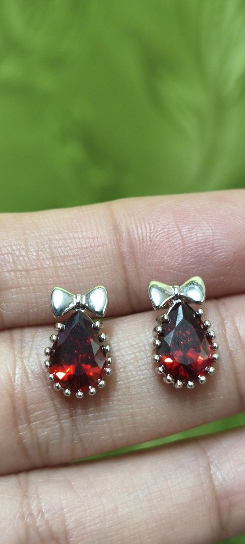 Red Gemstone Bow Earrings (Category: Earrings) located in Quezon City. Submitted by gemaicloset (Listing ID 1461144404, Image 1). Description: - Cute red teardrop gemstone earrings - Adorable silver bow detail on top - Silver-toned metal setting with delicate beaded edges - Perfect for adding a vibrant splash of color - Ideal for gifting or a personal treat.