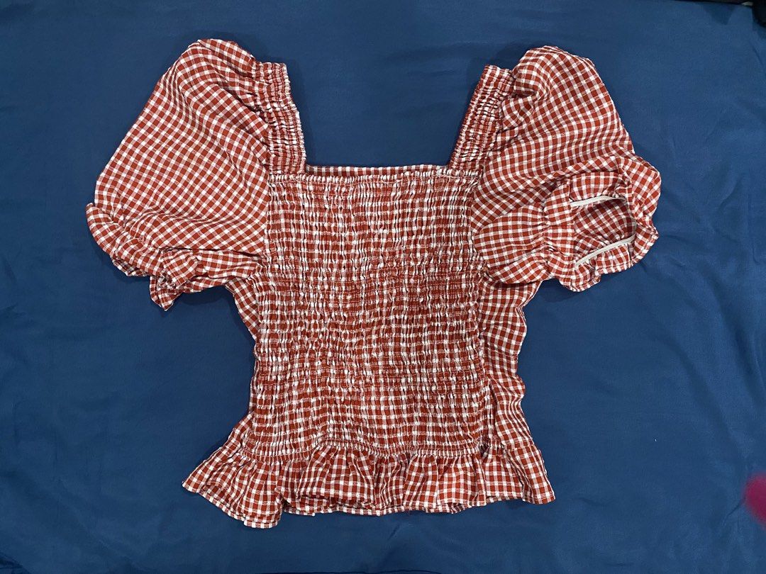 Red Gingham Square Neck Puff Sleeve Button Up Top (Category: Blouses) located in Manila. Submitted by escherichiaa (Listing ID 1461294469, Image 2). Description: - Adorable red gingham pattern - Flattering square neckline - Chic puff sleeves - Functional front buttons - Comfortable smocked back - Pretty ruffled hemline - Versatile for casual or dressed-up occasions.