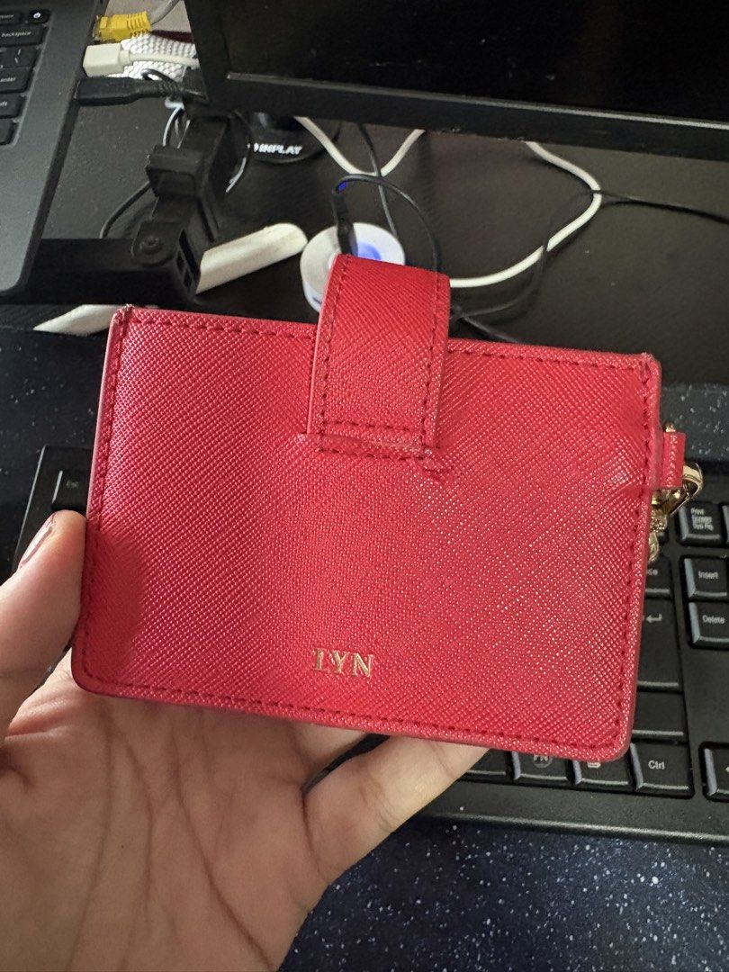 Red LYN Card Holder with Chain (Category: Wallets & Card holders) located in Manila. Submitted by crisdancal (Listing ID 1461264274, Image 2). Description: - Brand: LYN - Color: Red exterior, Light pink interior - Closure: Snap button - Strap: Detachable gold chain strap - Features: Multiple card slots, Textured exterior finish - Function: Ideal for keeping cards and essentials organized Original price: 2200.