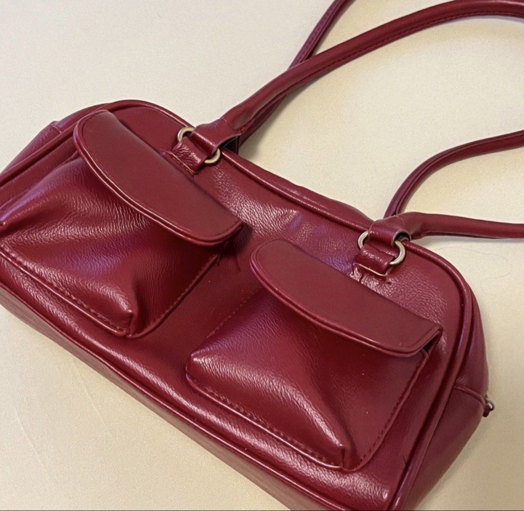 Red Shoulder Bag with Front Pockets (Category: Shoulder Bags) located in Antipolo. Submitted by elmclothing (Listing ID 1461138615, Image 1). Description: - Cute red shoulder bag - Two front pockets with flaps - Faux leather material - Thin straps with metal ring attachments - Ideal size for everyday essentials - Adds a great pop of color to any outfit.