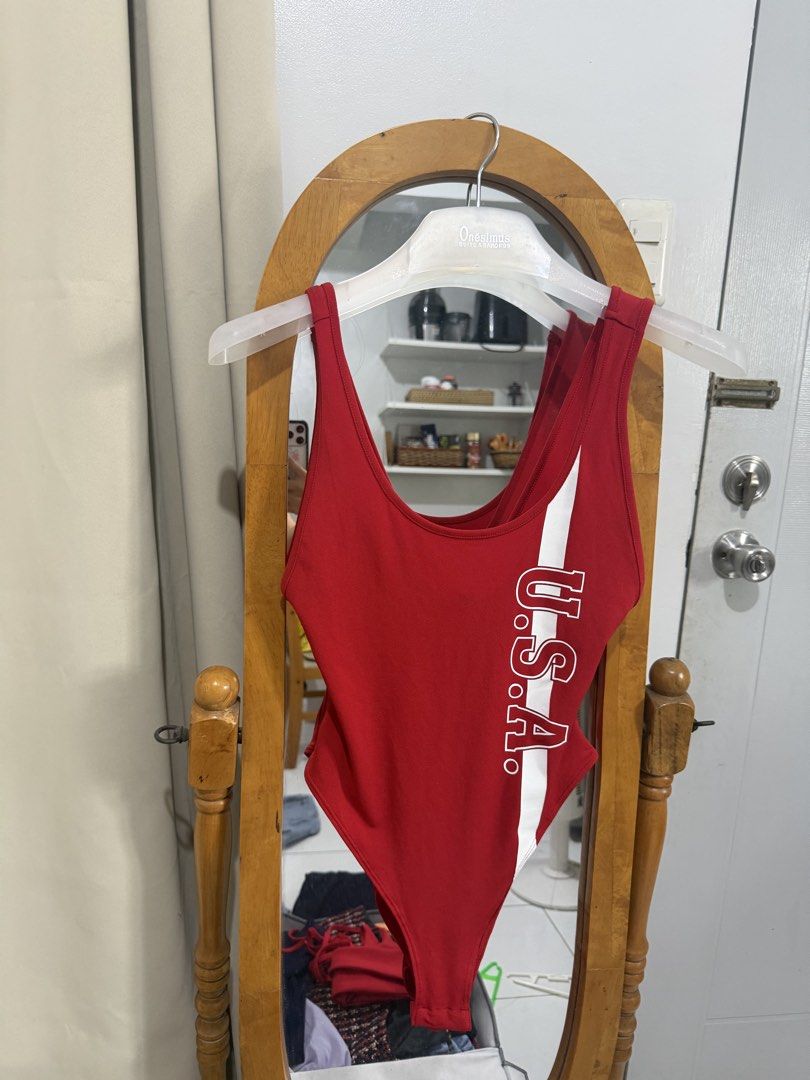 Red USA Graphic Bodysuit (Category: Others Tops) located in Mandaluyong City. Submitted by chocofudge__ (Listing ID 1461156544, Image 1). Description: - Red one-piece bodysuit - White 'U.S.A.' graphic on the side - Scoop neck - Low scoop back - Stretchy material for a comfortable fit - Ideal for casual wear or themed outfits.