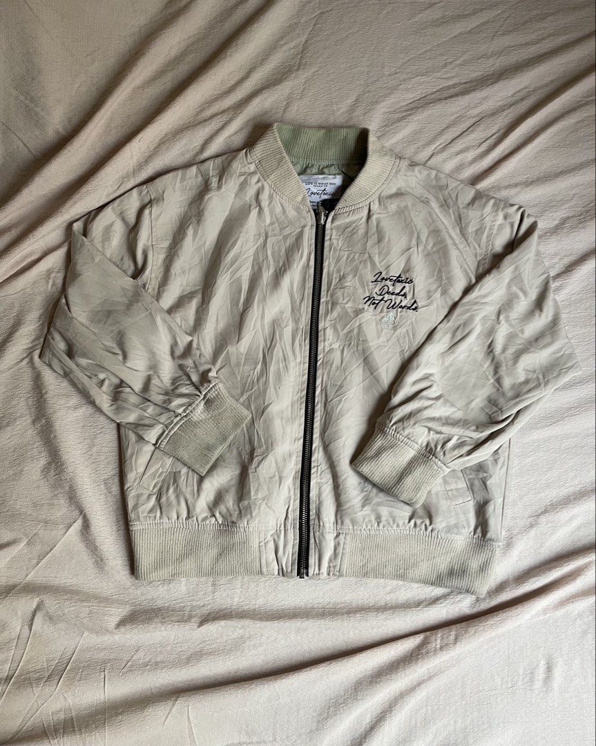 Reversible bomber jacket (Category: Coats, Jackets and Outerwear) located in Manila. Submitted by stepsole (Listing ID 1461152060, Image 1). Description: - Lightweight beige bomber jacket - Subtle green collar detail - Ribbed cuffs and hem for a snug fit - Small embroidered detail on the chest - Convenient zipper closure - Ideal for versatile layering.