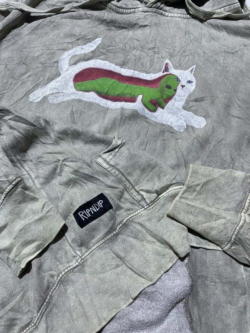 RIPNDIP Grey Cat Alien Graphic Hoodie (Category: Hoodies) located in Pangantucan. Submitted by calmwhale_cb83a8 (Listing ID 1461202736, Image 3). Description: - Grey RIPNDIP hoodie featuring a cat and alien graphic. -with minimal hairline crack - Crafted from 100% comfortable cotton. - Designed with a convenient front pocket and adjustable drawstring hood. - Proudly made in Pakistan. - Ideal for everyday casual wear..