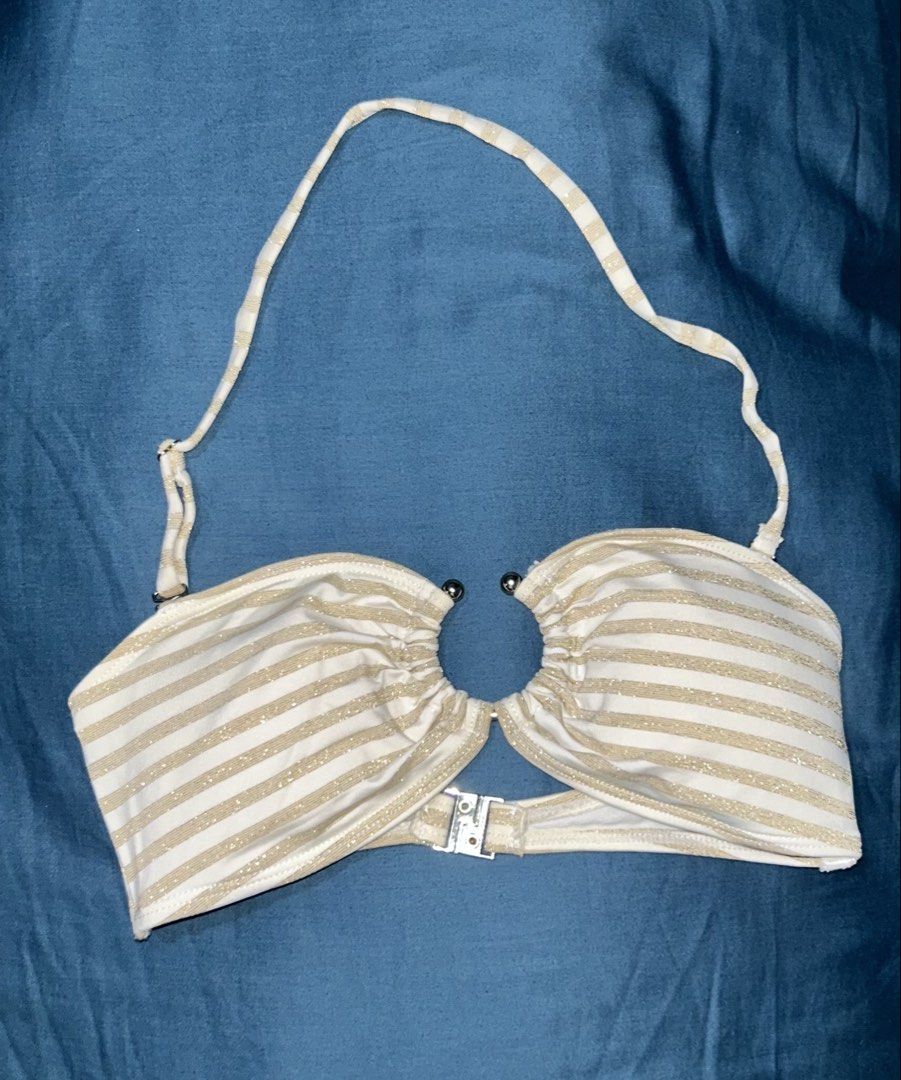 River Island Gold Stripe Ring Halter Bikini Top (Category: Bikinis & Swimsuits) located in Palo. Submitted by kaleidoscope_676 (Listing ID 1461123082, Image 1). Description: - Gold and white striped bikini top - Ring detail at the front - Halter neck strap - Clasp closure at the back - Brand: River Island.