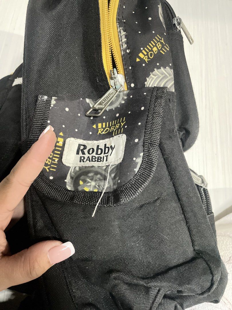 Robby Rabbit Monster Jump Kids Backpack (Category: Babies & Kids Fashion) located in Quezon City. Submitted by prelovedclotheskimukays (Listing ID 1461266462, Image 3). Description: - Black kids backpack with a fun 'Monster Jump' monster truck graphic. - Features eye-catching yellow accents. - Convenient side pockets for easy access. - Interior 'Robby Rabbit' tag. - Spacious enough for school essentials or day trip necessities..