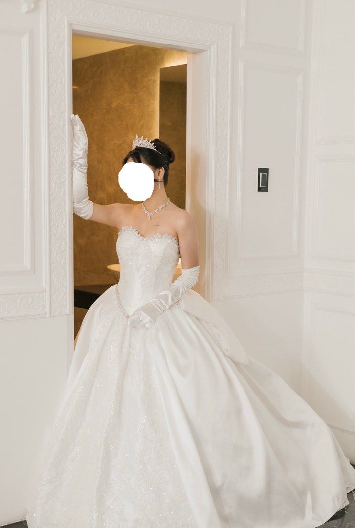 Royal Wedding Gown (Corset) (Category: Evening dresses & gowns) located in Manila. Submitted by vastearth-4b6e (Listing ID 1461130333, Image 2). Description: Selling my wedding gown for a cheaper price - Beautiful white wedding ball gown - Strapless bodice with intricate beading - Full skirt with a long train - Corset back - Removable bow at the back - 6 Hoop Petticoat included - Matching tiara and veil included - Gloves also included - Worn once