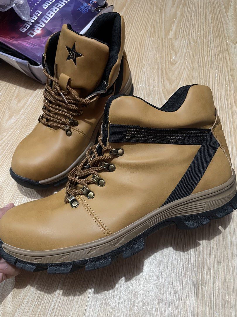 Safety shoes size 45 (Category: Boots) located in Manila. Submitted by artypaper_25 (Listing ID 1461255790, Image 1). Description: - Tan colored work boots - Lace-up style for a secure fit - Durable, sturdy soles for tough conditions - Stylish black accents on sides and collar - Iconic star logo detail on the side - Ideal for outdoor activities and work environments.