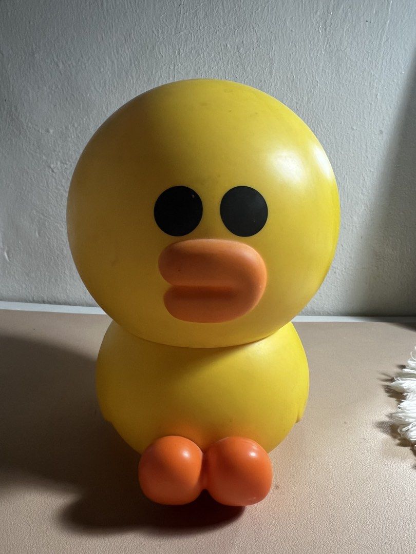 sally LINE FRIENDS (Category: Designer & Blind Box Toys) located in Valenzuela. Submitted by decluttering.manila (Listing ID 1461246082, Image 1). Description: Cute yellow duck toy. It's a container, you can store small items inside. The top part comes off. There's also a small plastic jar included. Great for organizing small trinkets or as a fun desk decoration. Bright yellow color..