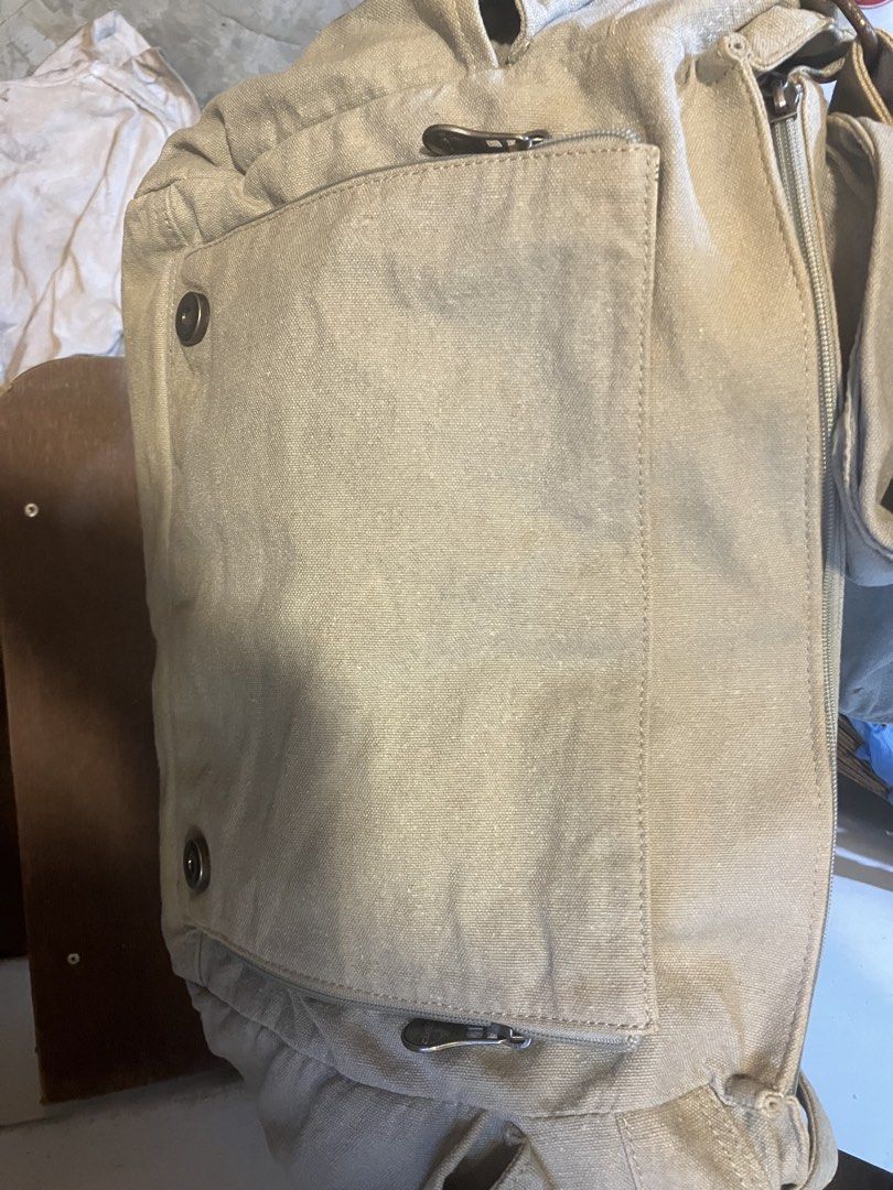 SATIVA Canvas Messenger Bag (ORIGINAL) (Category: Sling Bags) located in Quezon City. Submitted by ponpin (Listing ID 1461154208, Image 3). Description: - SATIVA messenger bag - Neutral light green color - Durable canvas material - Main compartment with zip closure - Internal pockets for organization - Exterior pocket with button closure - Adjustable strap for comfortable carrying - Ideal for everyday use Issue - Rust discoloration Negotiable pri