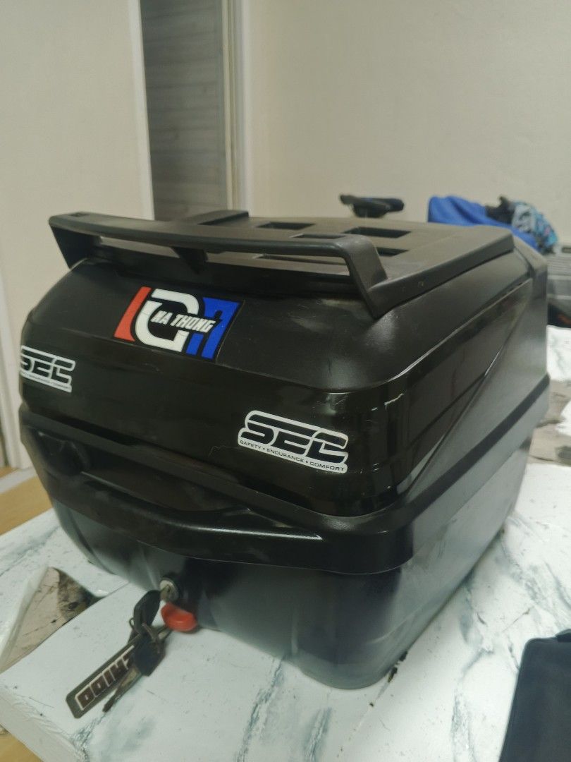 SEC Motorcycle Top Box with Keys (Category: Other Motorcycles Parts and Accessories) located in Manila. Submitted by annecbau (Listing ID 1461218215, Image 2). Description: SEC motorcycle top box with 'Na Thong' and 'K-Workz Team' stickers. Includes keys. Spacious for your essentials. Mounts on your motorcycle rack. Ideal for daily rides and longer trips. 36 liters.