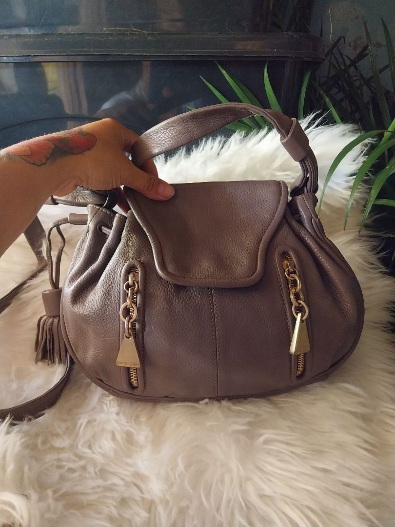 See By Chloe Leather Drawstring Shoulder Bag Taupe (Category: Luxury Bags & Wallets) located in Caloocan City. Submitted by gentleforest.e6775a (Listing ID 1461146494, Image 1). Description: - Brand: See By Chloe - Color: Taupe - Material: Leather - Style: Drawstring Shoulder Bag - Hardware: Gold tone - Features: Zipper details, tassel accent, top handle, detachable shoulder strap - Origin: Made in India.